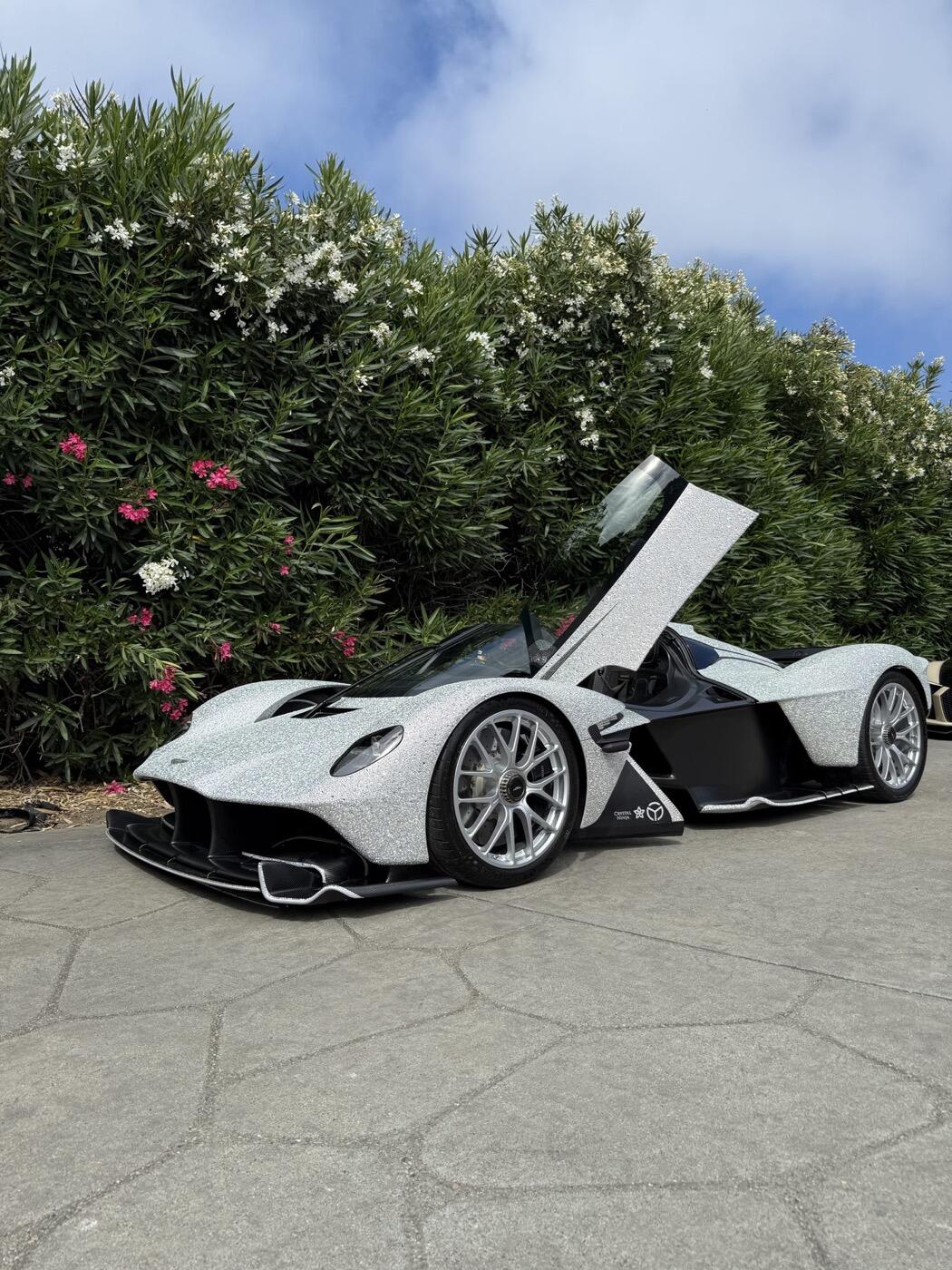 A hypercar with the doors up after a detail
